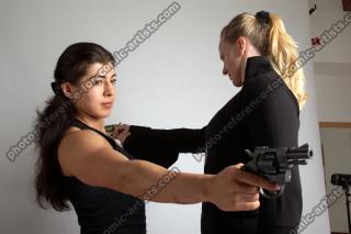 OXANA AND XENIA STANDING POSE WITH GUNS 2